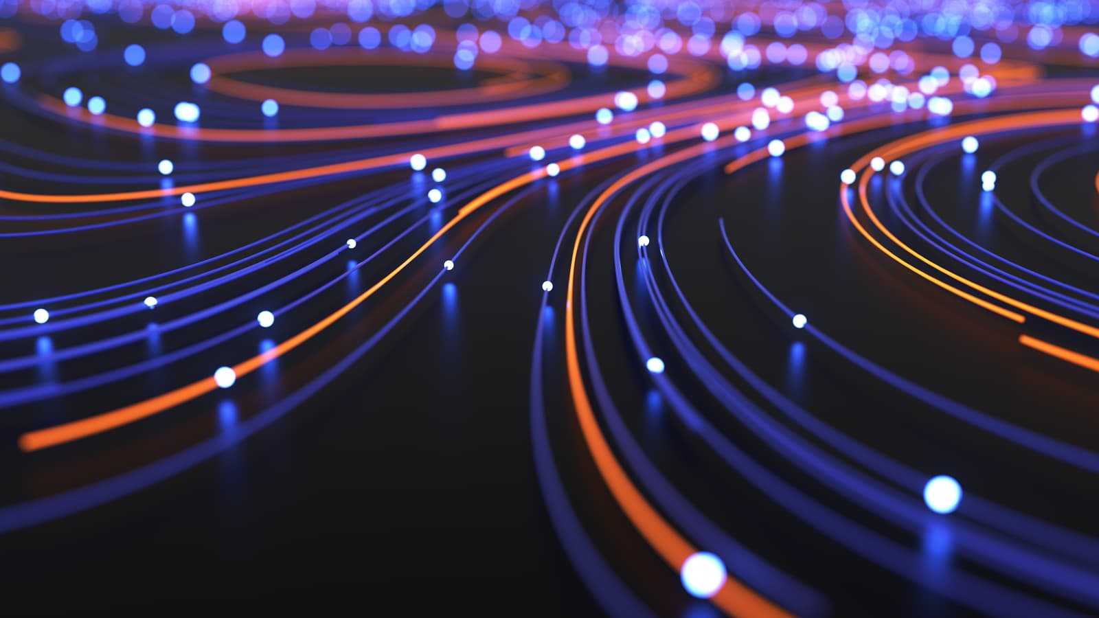 Plusieurs cables néon de couleurs orange et bleu posés sur le sol.